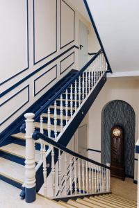 a staircase in a house with blue and white walls at Hotel Kleiner Riesen in Koblenz