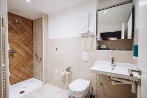 a bathroom with a toilet and a sink and a shower at Hotel Kleiner Riesen in Koblenz +106 photos