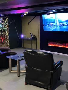 a living room with a fireplace and a tv at Revelation Home in Chicago
