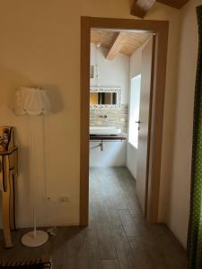 a hallway with a kitchen and a door to a room at Verso Est in Petralia Soprana +29 photos