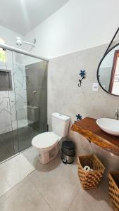 a bathroom with a toilet and a shower and a sink at Saíra Chalés in Lençóis +25 photos