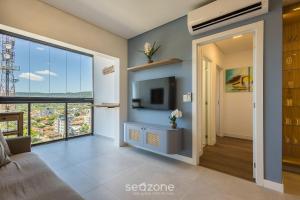 a living room with a large window and a television at Apt w/ BBQ and Partial Ocean View ALE0803 in Piçarras