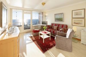 a living room with a couch and a table at Strandkieker in List