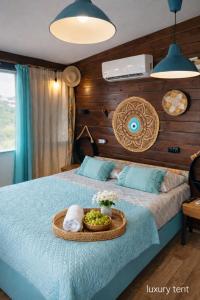 a bedroom with a bed with a tray of food on it at dream tiny house & luxury tent in Chania