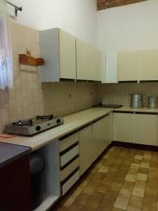 a kitchen with white cabinets and a stove in it at Mountain Guesthouse in Pretoria