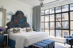 a bedroom with a large bed and a large window at The Whitby Hotel in New York