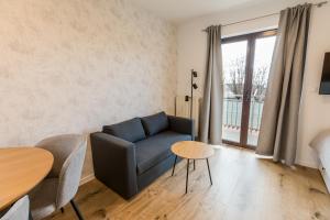 a living room with a couch and a table at Apartments Dorijan with Pool in Matulji
