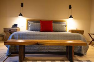 a bedroom with a bed with a red pillow at Villa Ecuestre in Cedro