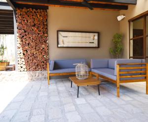 a patio with two blue couches and a table at Villa Ecuestre in Cedro