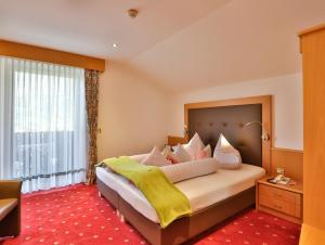 a bedroom with a large bed with a large window at bei Martin's in Morter