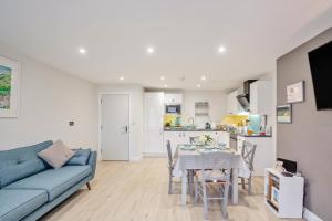 a living room with a blue couch and a table at 2 Bed in Benllech oc-t34071 in Benllech