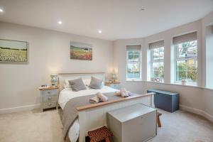 a bedroom with a bed with a desk and windows at 2 Bed in Benllech oc-t34071 in Benllech