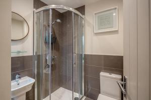a bathroom with a shower and a toilet and a sink at 2 Bed in Benllech oc-t34071 in Benllech +22 photos
