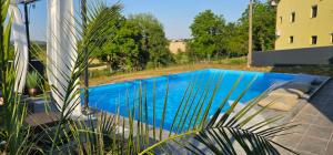 a swimming pool in front of a building at Villa Aida in Cazin