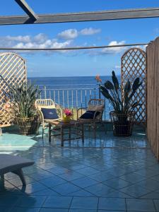 a patio with chairs and a view of the ocean at Hotel Mezzatorre in Ventotene