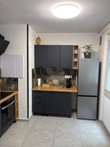 a kitchen with a white refrigerator and a counter at Apartmán Leo in Kežmarok