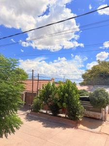 a group of trees in a courtyard with a sky at Hospedaje Catriel Habitación Privada con Check-in Autónomo in Catriel +11 photos