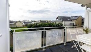 a balcony with a white table and chairs on it at Studio avec balcon, 4 personnes in Quiberon