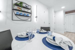 a white dining room with a white table with blue plates and glasses at Golf Coast Bleu II - 3158 in Zephyrhills +40 photos