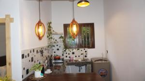 a kitchen with two lights hanging over a sink at Cozy place in Ahangama +22 photos