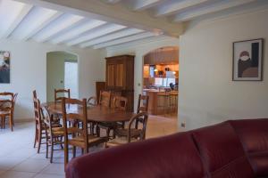 a kitchen and dining room with a table and chairs at L'Ancien Relais in Genouilly