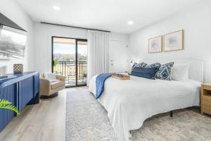 a bedroom with a large bed and a balcony at Golf Coast Bleu Studio - 3160 in Zephyrhills