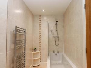 a bathroom with a shower and a bath tub at Grange Cottage in Crediton +38 photos
