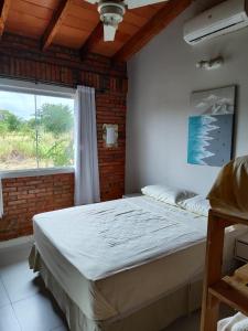 a large bed in a room with a window at Casita de Natalia in San Bernardino
