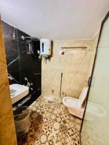a bathroom with a toilet and a sink at Shree ji palace hotel in Udaipur +49 photos