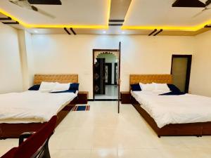 a room with two beds and a mirror at Shree ji palace hotel in Udaipur