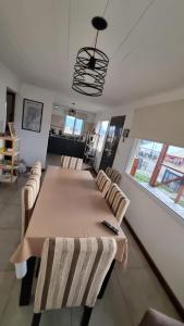 a dining room with a large table and chairs at El refugio de Marisela in Trevelín