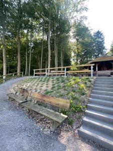 a wooden bench sitting next to a set of stairs at Alte Weinstuben Steinfelder Hof - B&B in Ellenz-Poltersdorf