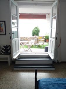 an open door to a patio with a table and chairs at la terrazza relax in Corniglia +28 photos