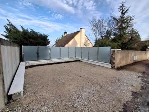 a privacy fence in front of a house at Studio Privé Dijon in Dijon