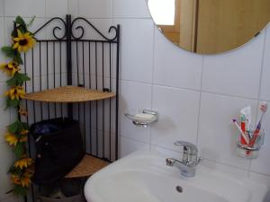 a bathroom with a sink and a mirror at Grand chalet en Gruyère in Sorens +11 photos