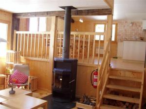 a living room with a woodburning stove in a house at Grand chalet en Gruyère in Sorens