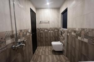 a bathroom with a toilet and a shower at Private 2BD Apartment Opposite Dha Phase 8 in Lahore +13 photos
