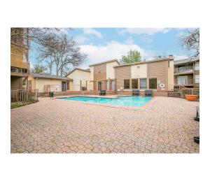 a house with a swimming pool in a yard at Elegant 2Bed & 2 Bath Comfort in Dallas