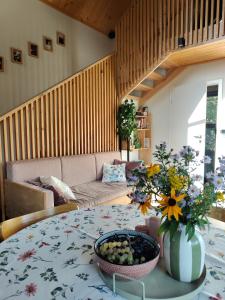 a living room with a table and a couch at Domek Ponad Mgłami in Laskowa