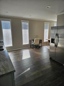 a kitchen with a stainless steel refrigerator and a table at Apartment in Cleveland in Cleveland