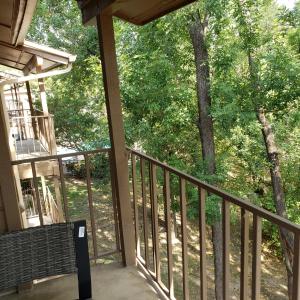 a porch of a house with a bench and trees at Elegant 2Bed & 2 Bath Comfort in Dallas
