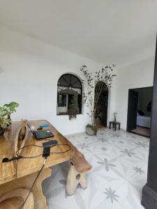 a room with a wooden desk with a laptop on it at Hotel Capilla del sol in Garzón