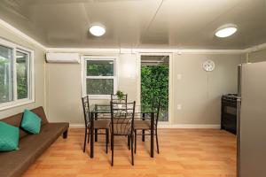 a living room with a table and chairs and a couch at Tiny Homes Tamarindo in Tamarindo