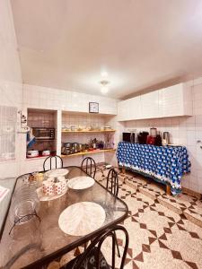 a kitchen with a table and chairs and a couch at Mansão Bardo in Petrópolis