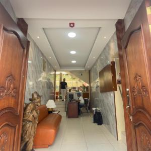 a hallway with a couch and a person sitting in a chair at Viena Internacional B&B - Rooftop in Quito