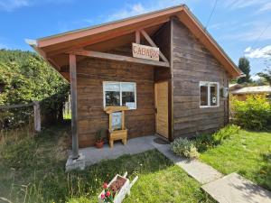 a small shed with a sign that reads cottages at Terra Patagónica in Puerto Tranquilo