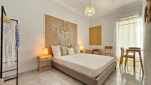 a bedroom with a bed and a table and chairs at Plaka View Nest in Plaka Milou