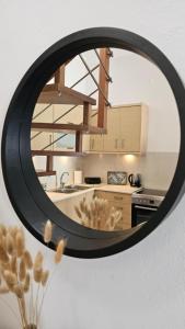a mirror hanging on a wall in a kitchen at Plaka View Nest in Plaka Milou +8 photos