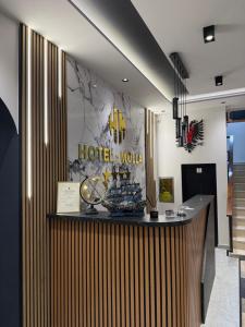 a hotel lobby with a counter with a sign on the wall at Molla Hotel Restorant in Shëngjin