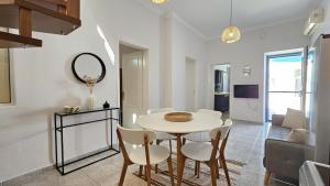 a dining room with a table and chairs and a mirror at Plaka View Nest in Plaka Milou